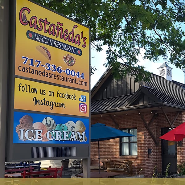 Castañeda's Mexican Restaurant sign with contact info, social media, and ice cream next to the building.