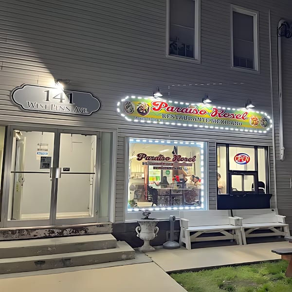 Exterior of Castañedas Mexican Restaurant at night, with a bright "Paraiso Rosel" sign and an "OPEN" sign.