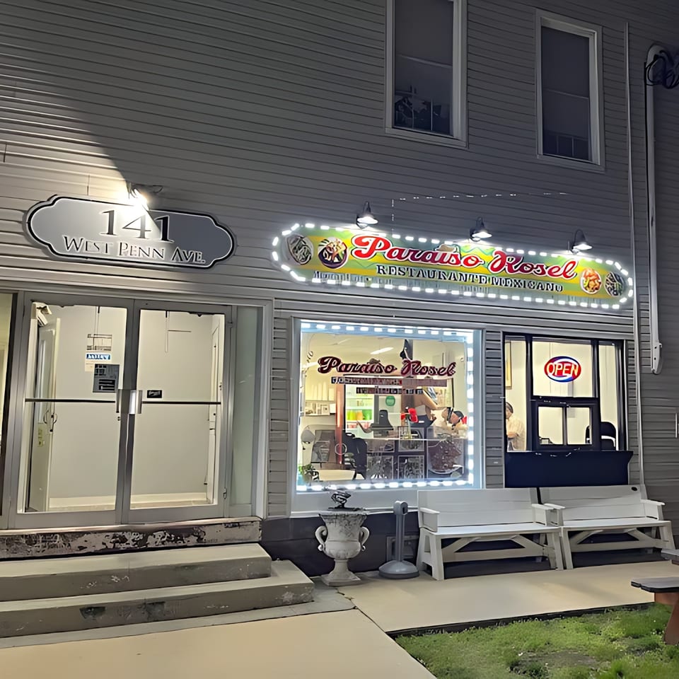Exterior of Castañedas Mexican Restaurant at night, with a bright "Paraiso Rosel" sign and an "OPEN" sign.