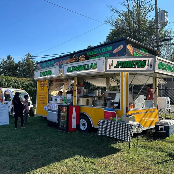 Castañedas Mexican Restaurant food truck with customers, serving tacos, quesadillas, and Jarritos.