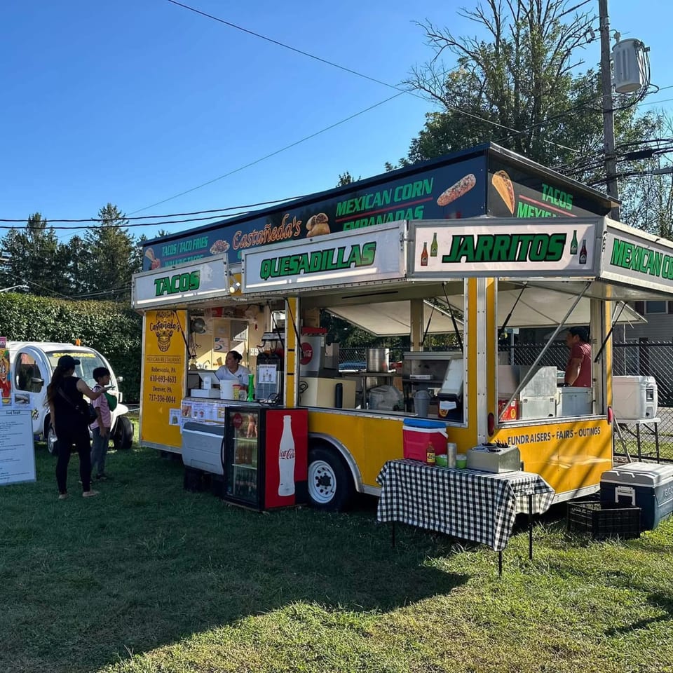 Castañedas Mexican Restaurant food truck with customers, serving tacos, quesadillas, and Jarritos.