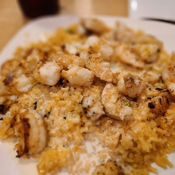 Close-up of Castañedas Mexican Restaurant's shrimp and rice dish, seasoned with pepper.